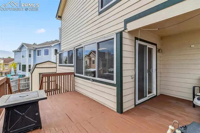 a view of a house with a wooden deck