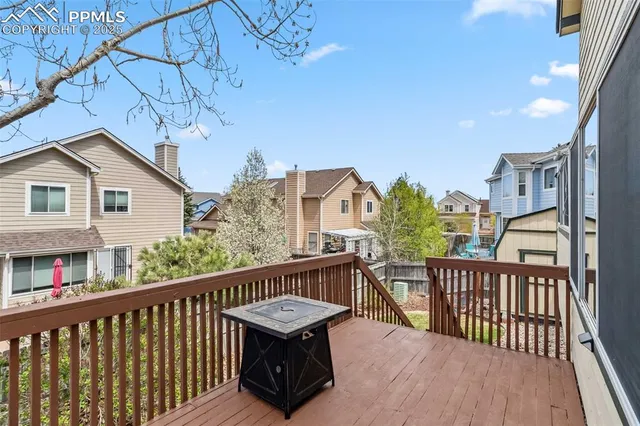 a view of a roof deck with wooden fence and floor