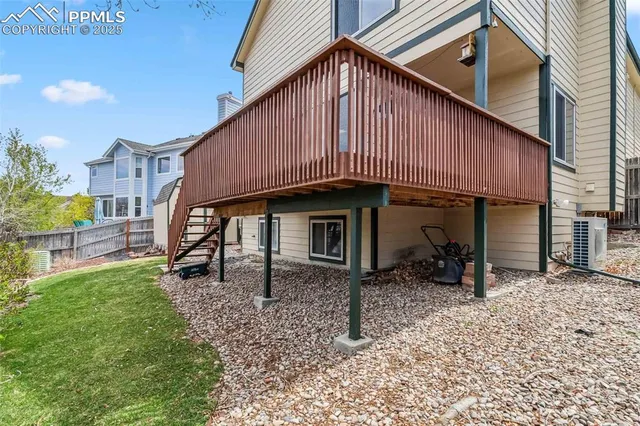 a backyard of a house with barbeque oven table and chairs