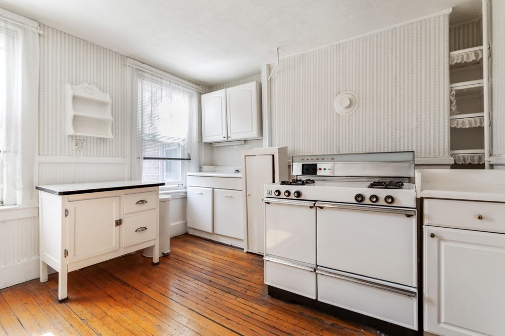 72 North Margin Street Boston, MA 02113 - Photo 15 of 42 a kitchen with white cabinets sink and white appliances