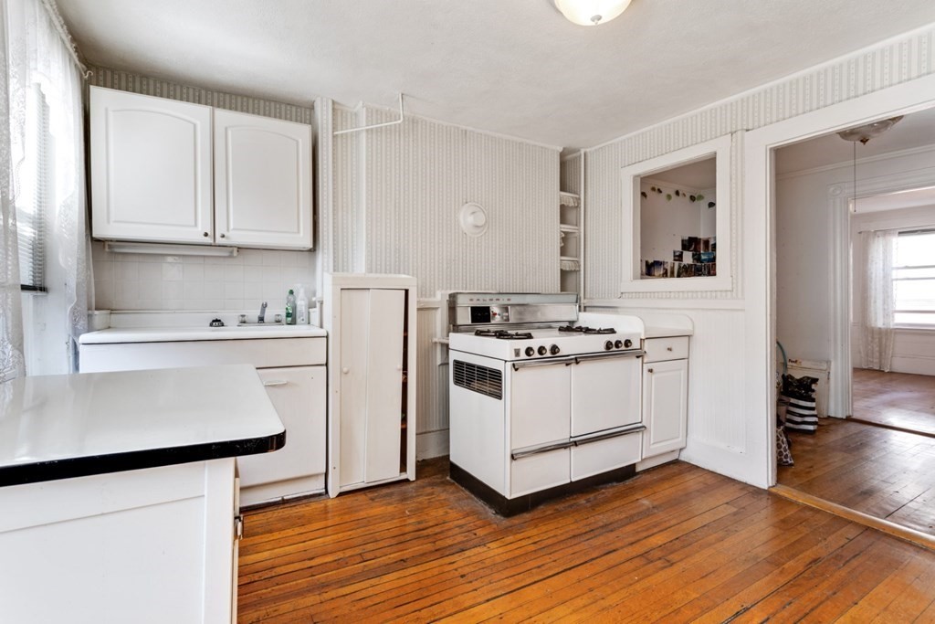 72 North Margin Street Boston, MA 02113 - Photo 16 of 42 a white kitchen with wooden floor
