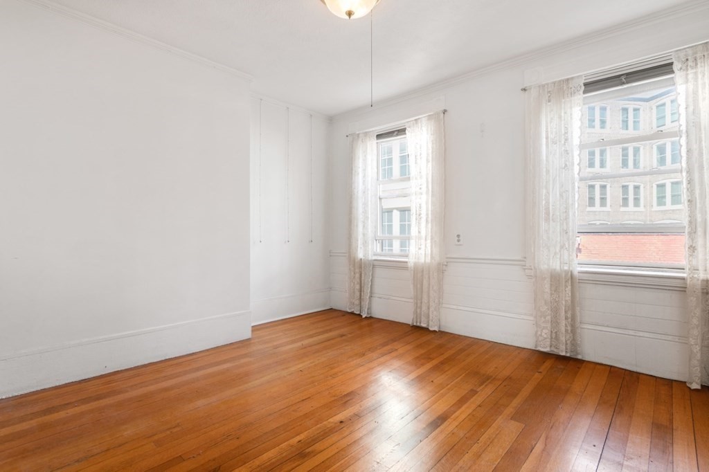 72 North Margin Street Boston, MA 02113 - Photo 19 of 42 an empty room with wooden floor cabinet and windows