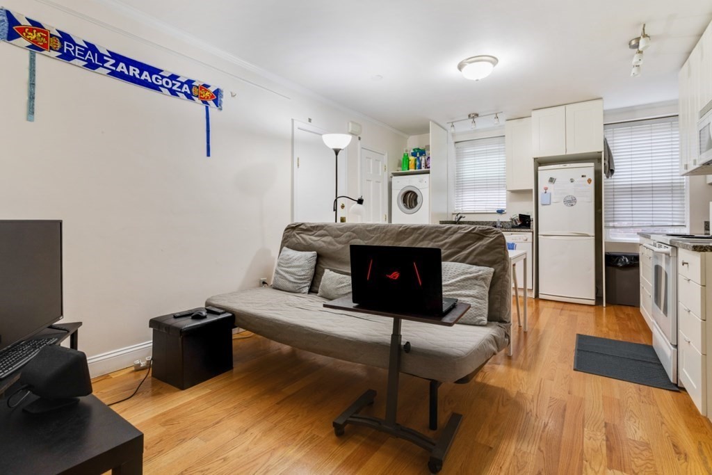 72 North Margin Street Boston, MA 02113 - Photo 35 of 42 a kitchen with stainless steel appliances a stove a refrigerator and a fireplace