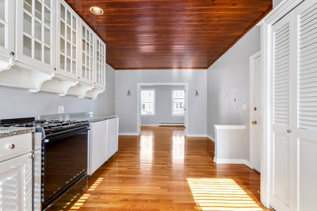 72 North Margin Street Boston, MA 02113 - Photo 10 of 42 a kitchen with stainless steel appliances granite countertop a stove and a refrigerator