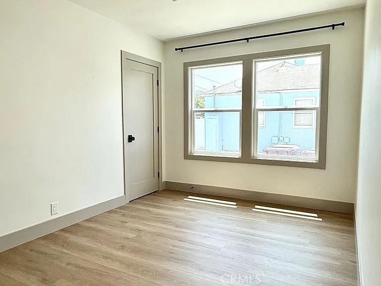 2510 Termino Avenue, Unit B Long Beach, CA 90815 - Photo 12 of 22 an empty room with wooden floor and windows