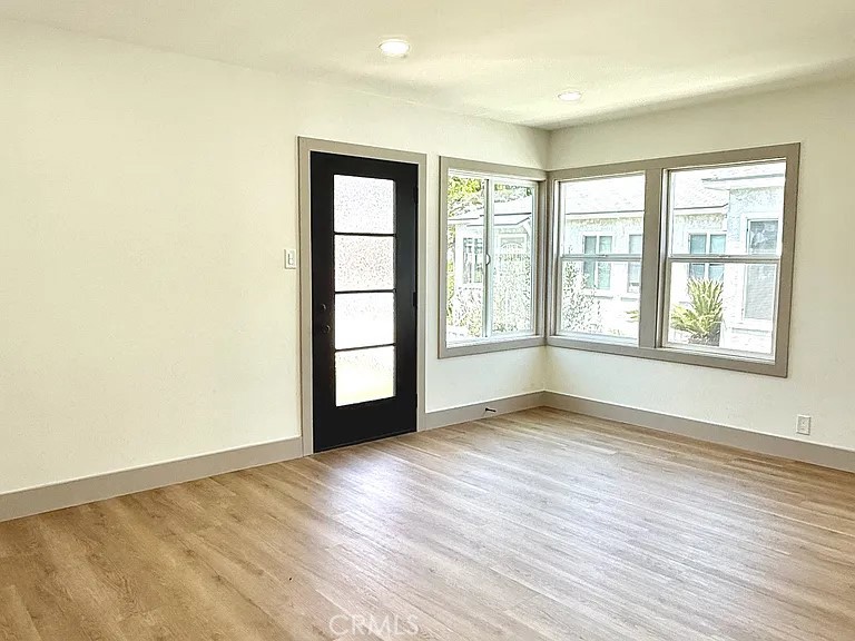 2510 Termino Avenue, Unit B Long Beach, CA 90815 - Photo 8 of 22 an empty room with wooden floor and windows