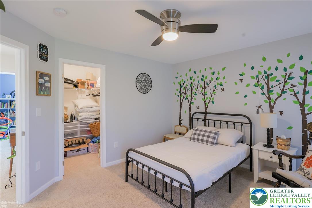 2168 Terry Road Nazareth, PA 18064 - Photo 37 of 81 a bedroom with a bed a window and a chandelier