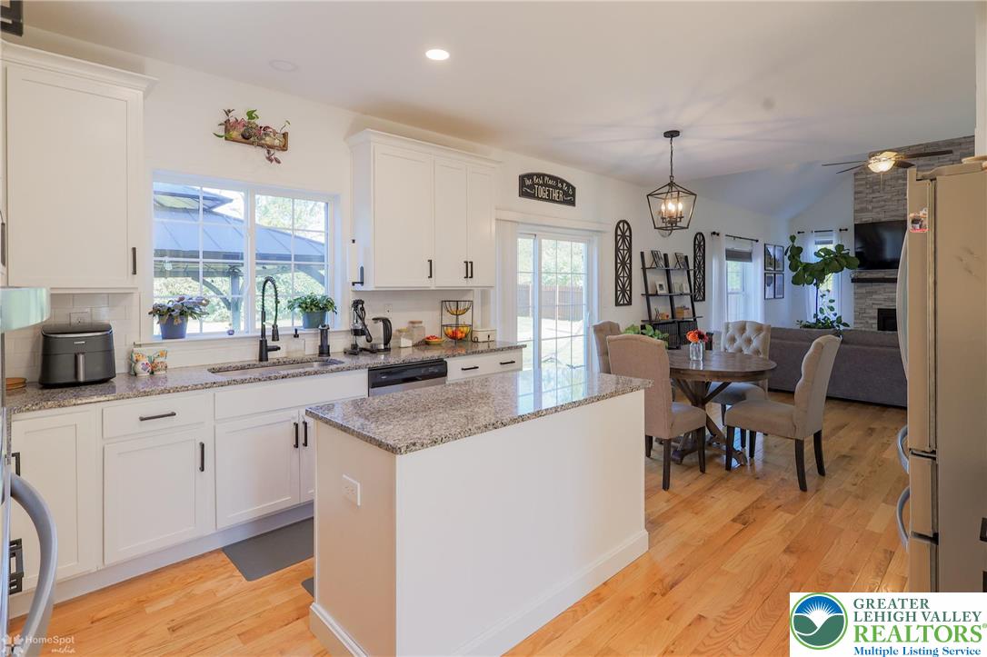 2168 Terry Road Nazareth, PA 18064 - Photo 8 of 81 a open kitchen with granite countertop a sink cabinets and wooden floor