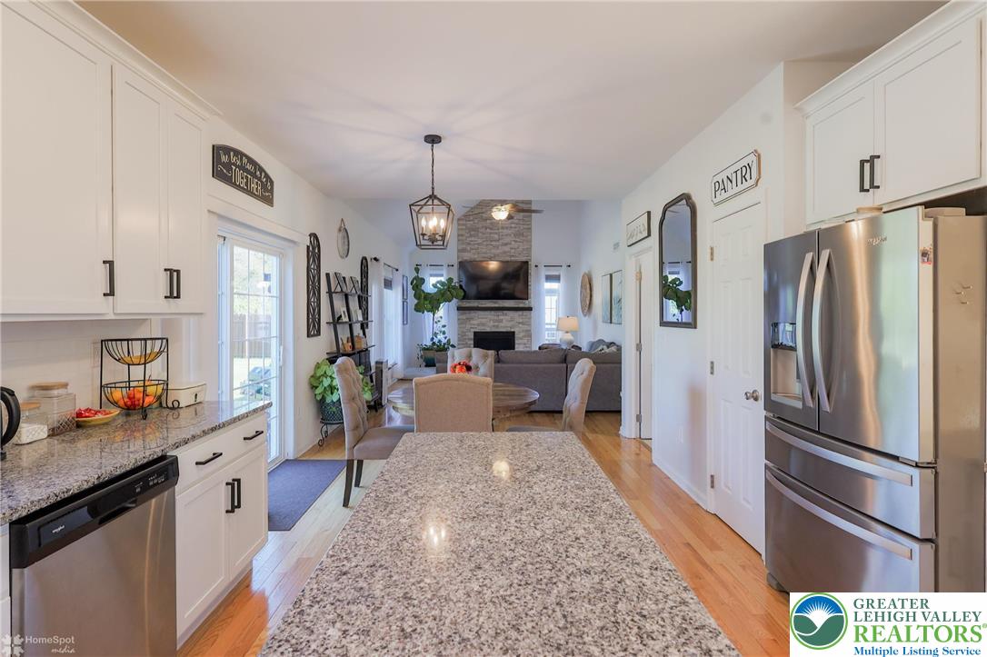 2168 Terry Road Nazareth, PA 18064 - Photo 9 of 81 a large kitchen with stainless steel appliances a refrigerator a sink dishwasher a oven and a dining table with wooden floor