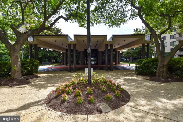 a view of a house with a tree in front of it