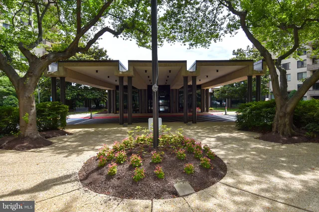a view of a house with a tree in front of it