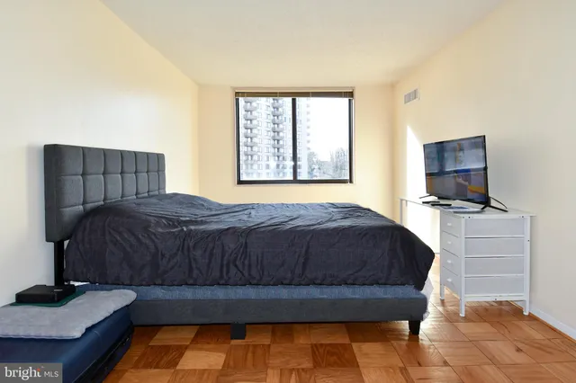 a bedroom with a bed and flat screen tv