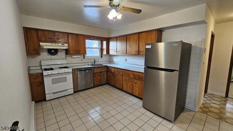 5 Passaic Avenue Nutley, NJ 07110 - Photo 4 of 12 a kitchen with stainless steel appliances a refrigerator sink and cabinets