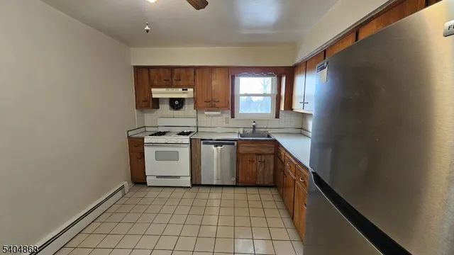 a kitchen with a stove sink and cabinets