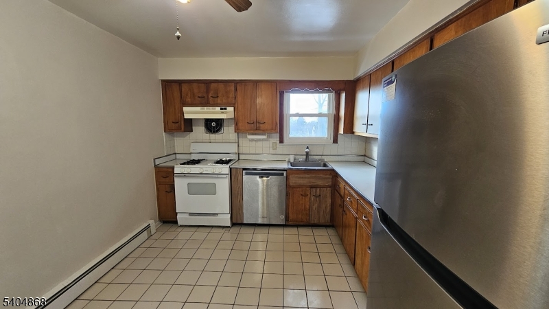 5 Passaic Avenue Nutley, NJ 07110 - Photo 5 of 12 a kitchen with a stove sink and cabinets