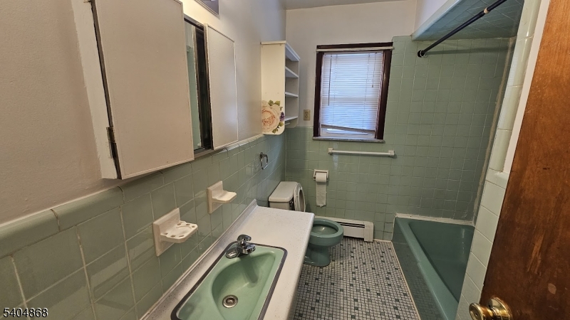 5 Passaic Avenue Nutley, NJ 07110 - Photo 9 of 12 a bathroom with a sink and toilet