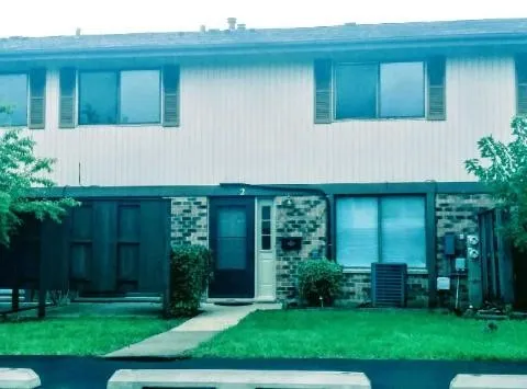 a view of a house with backyard and garden