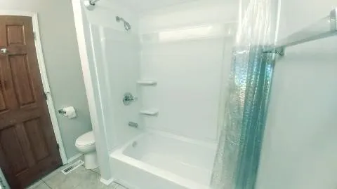a bathroom with a bathtub and a shower