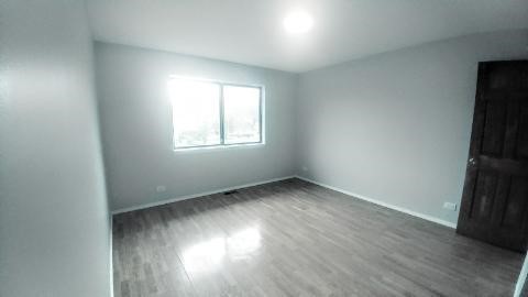 2 Tower Court Downers Grove, IL 60516 - Photo 19 of 20 an empty room with wooden floor and windows