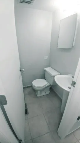 a white toilet sitting next to a white sink