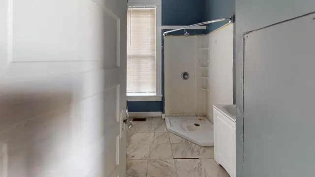 a bathroom with a glass shower door