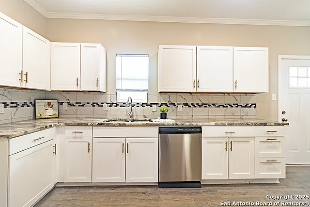 a kitchen with granite countertop white cabinets and white appliances