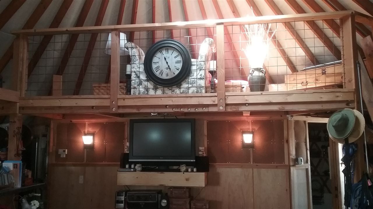 1448 20 Road Fruita, CO 81521 - Photo 5 of 20 a living room with a clock and a flat screen tv