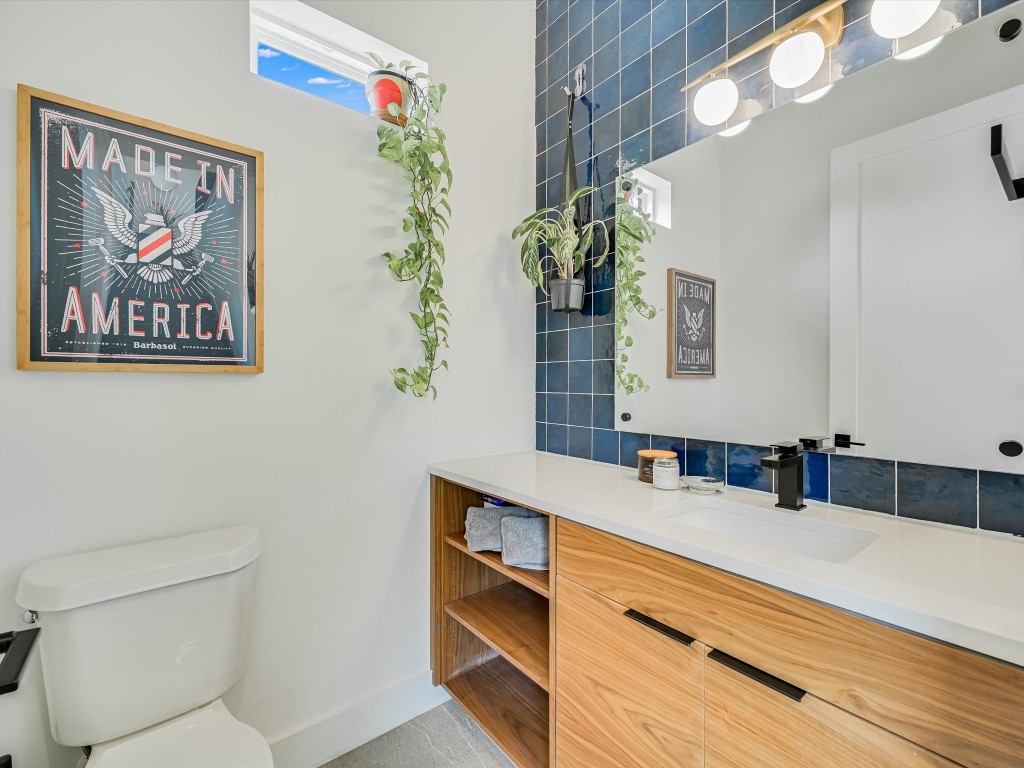 5603 Samuel Huston Avenue, Unit 1 Austin, TX 78721 - Photo 20 of 40 a bathroom with a sink a large mirror and a toilet