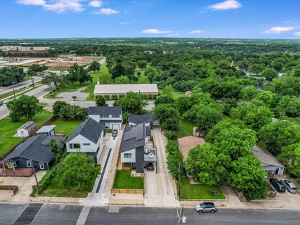 an aerial view of a house with a garden and yard