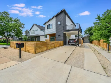 a kitchen with a stove a refrigerator a sink dishwasher with a dining table and chairs with wooden floor