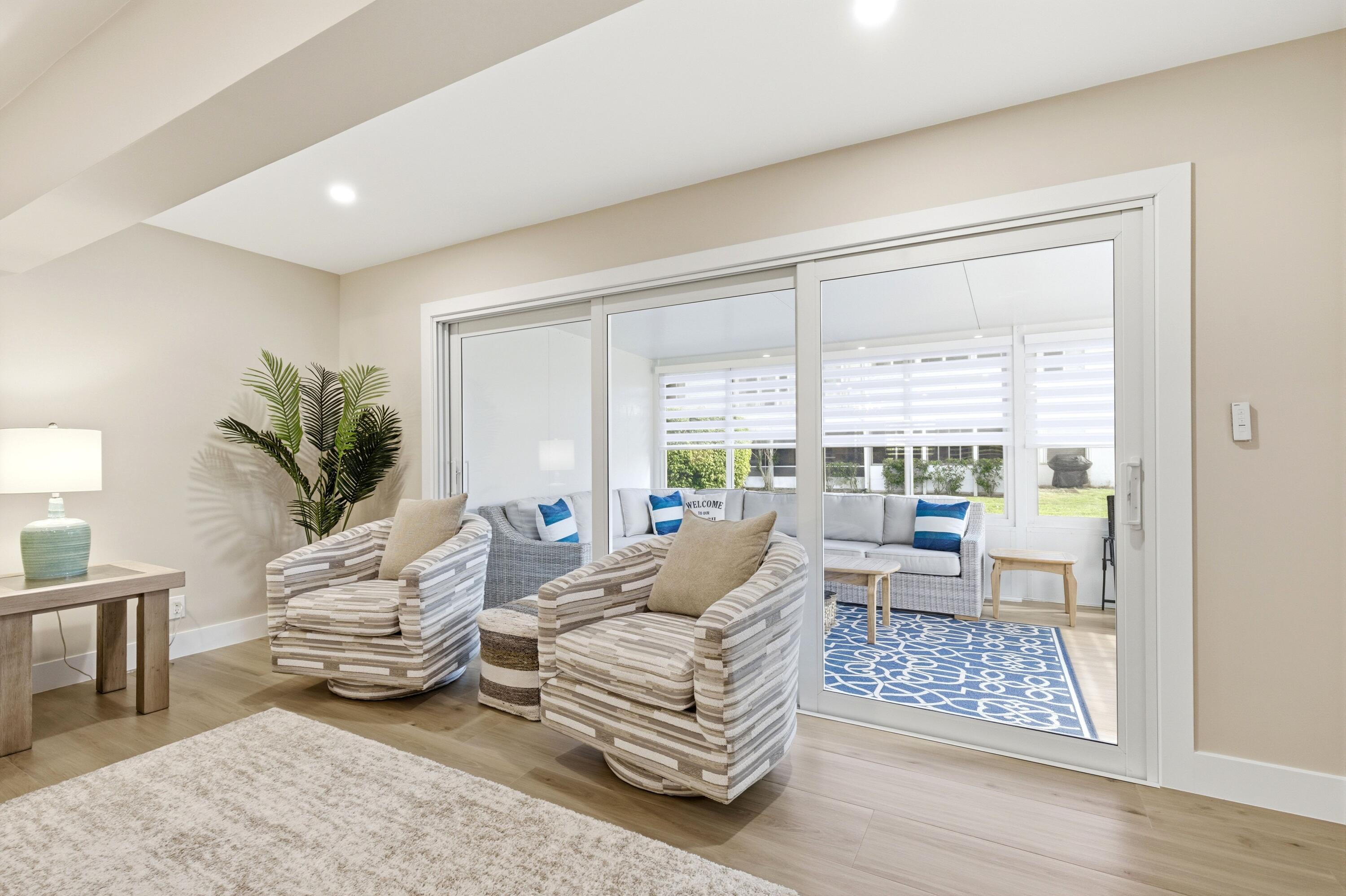 1415 Southwest 27th Avenue, Unit 104 Delray Beach, FL 33445 - Photo 15 of 43 a living room with furniture and a large window
