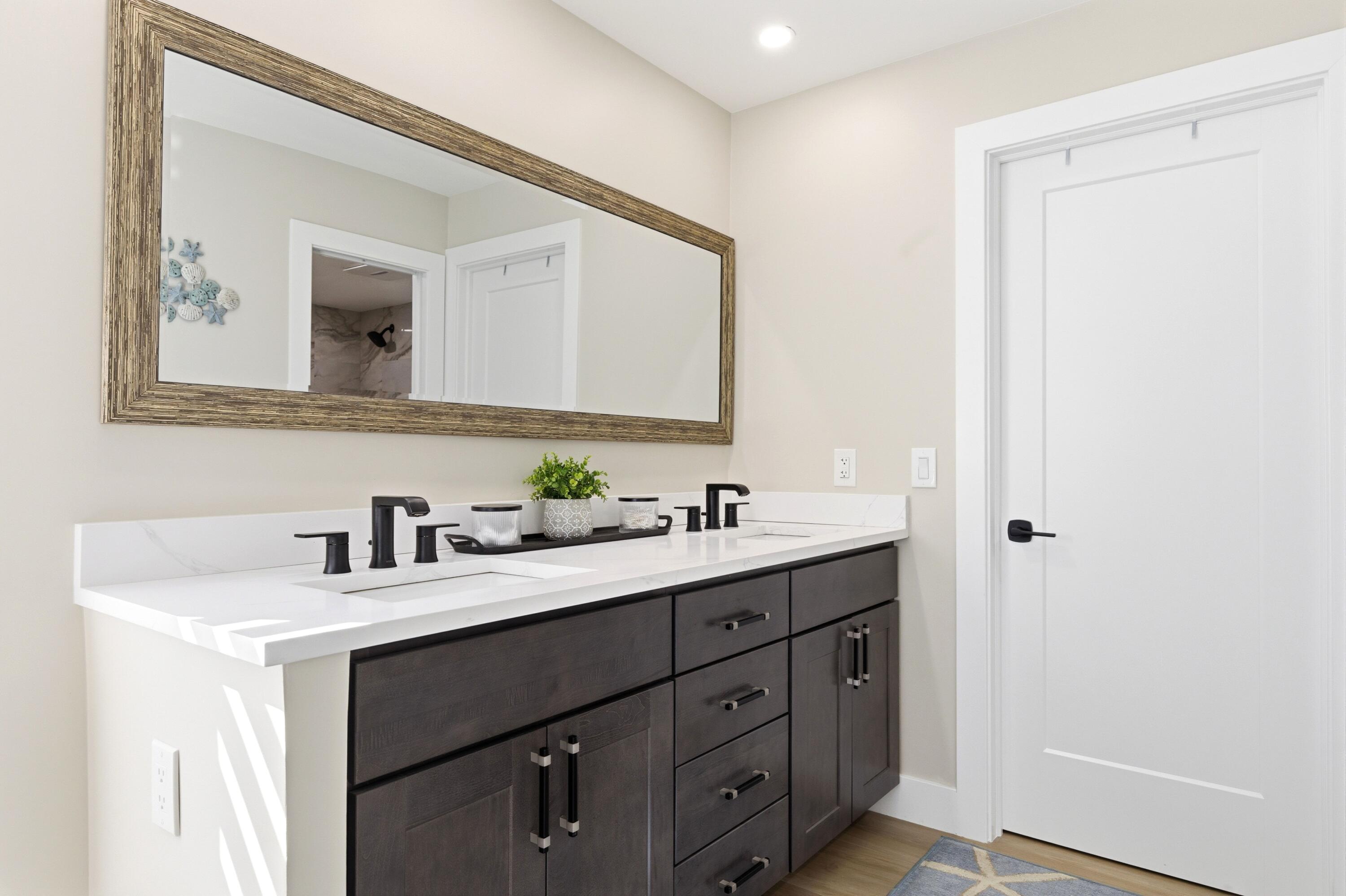 1415 Southwest 27th Avenue, Unit 104 Delray Beach, FL 33445 - Photo 24 of 43 a bathroom with a double vanity sink and mirror