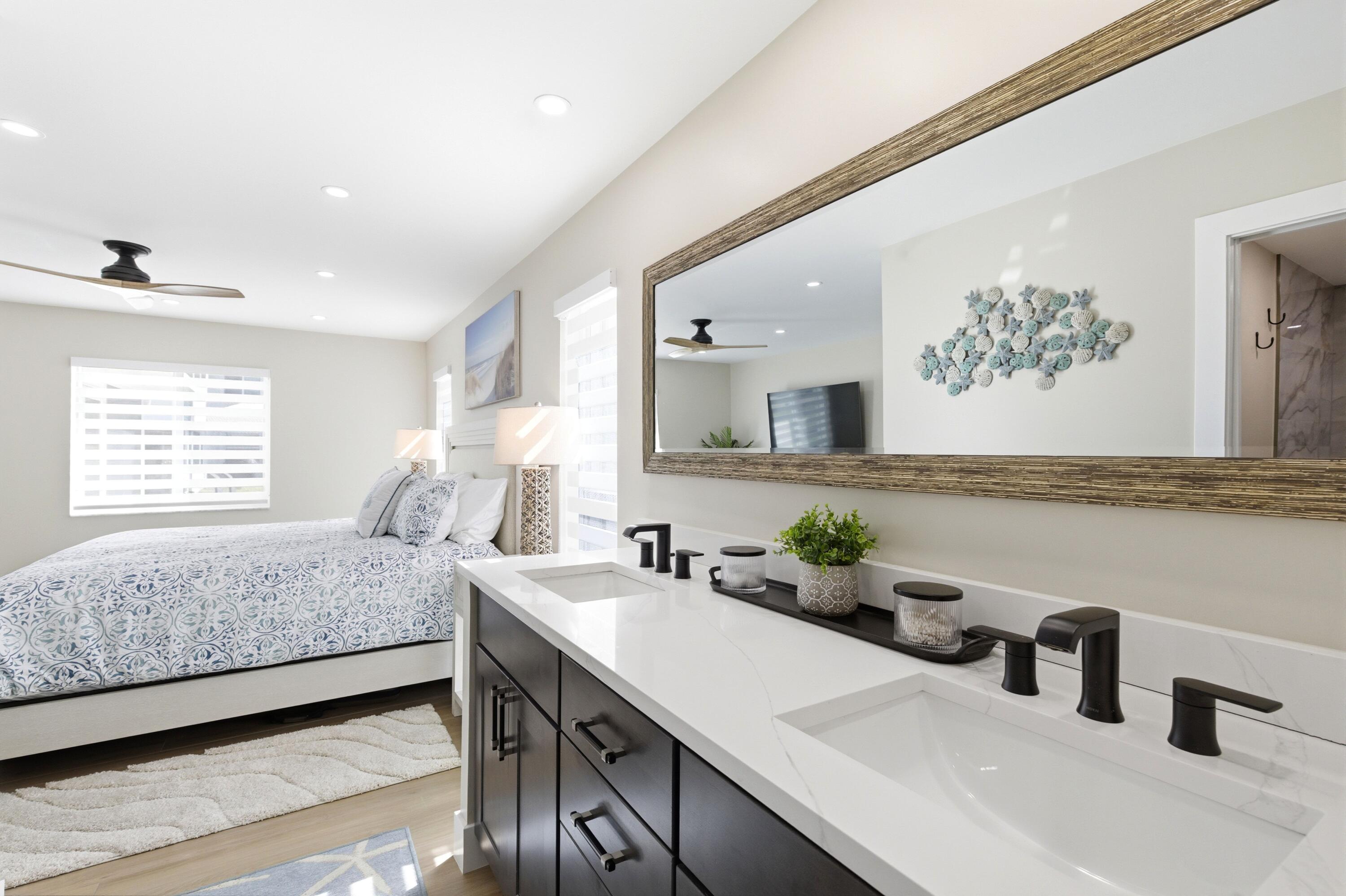 1415 Southwest 27th Avenue, Unit 104 Delray Beach, FL 33445 - Photo 25 of 43 a bedroom with a bed and a large mirror