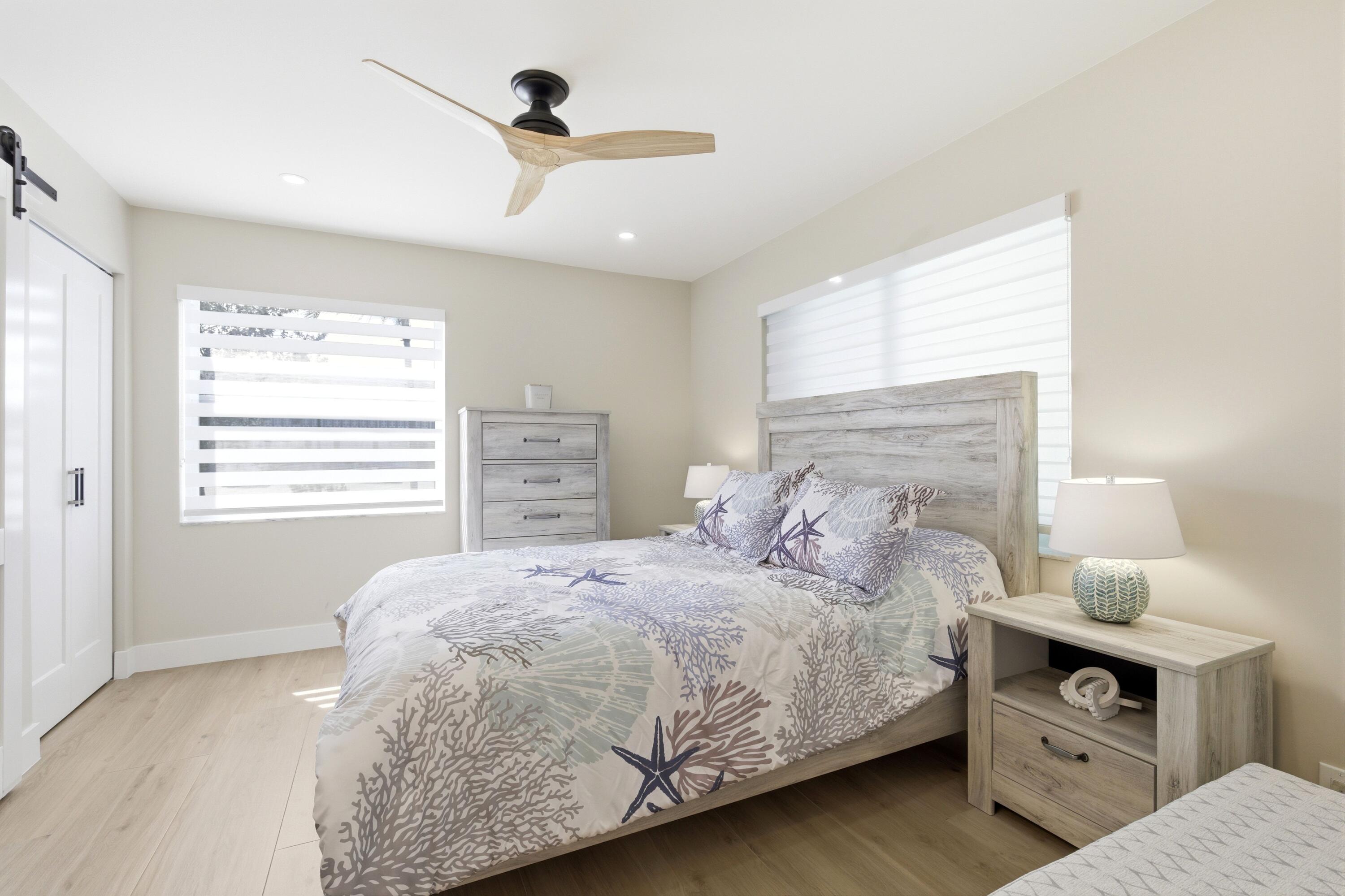 1415 Southwest 27th Avenue, Unit 104 Delray Beach, FL 33445 - Photo 28 of 43 a bedroom with a bed and a dresser