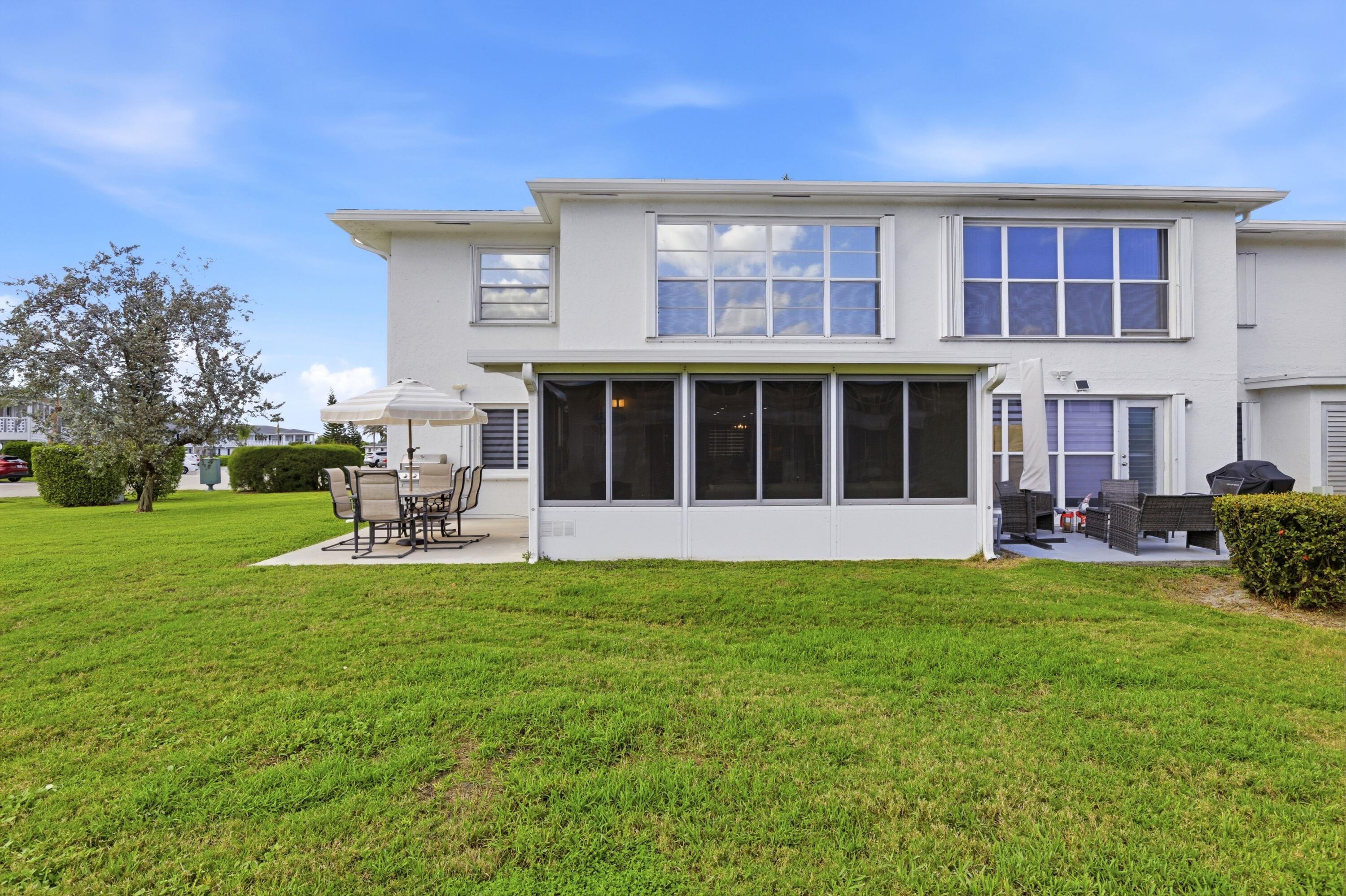 1415 Southwest 27th Avenue, Unit 104 Delray Beach, FL 33445 - Photo 34 of 43 a house view with a sitting space and garden