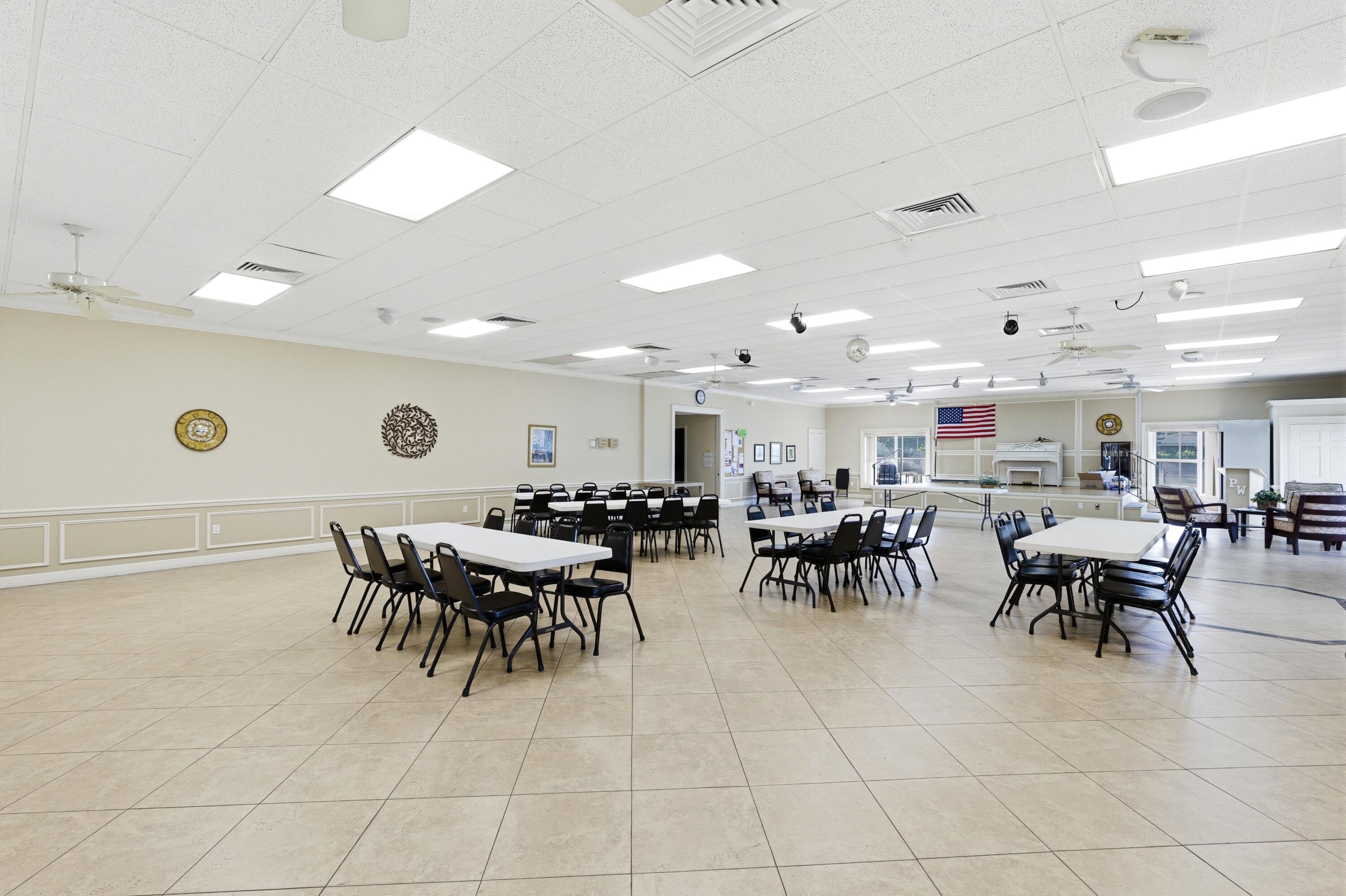 1415 Southwest 27th Avenue, Unit 104 Delray Beach, FL 33445 - Photo 37 of 43 a group of people sitting at tables in a room