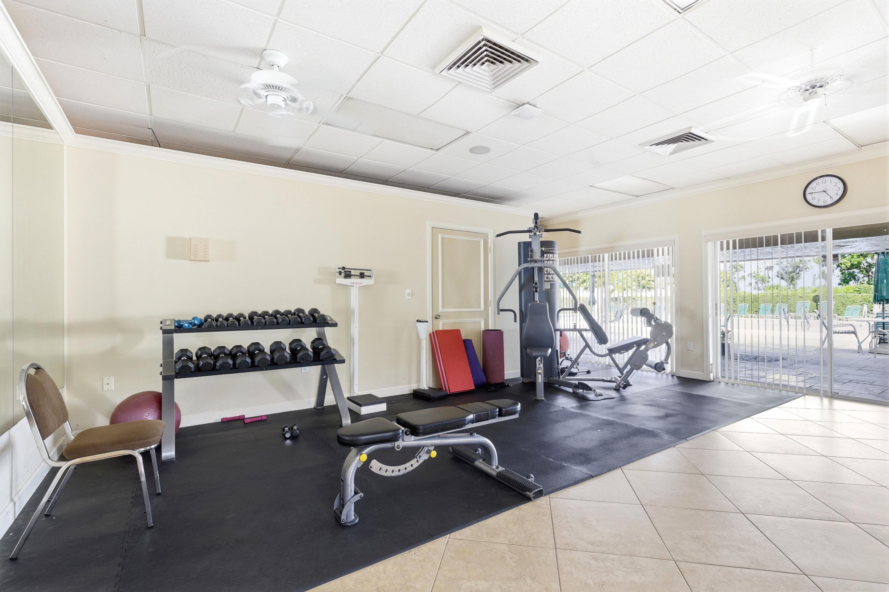 1415 Southwest 27th Avenue, Unit 104 Delray Beach, FL 33445 - Photo 39 of 43 a living room with patio furniture and a wooden floor