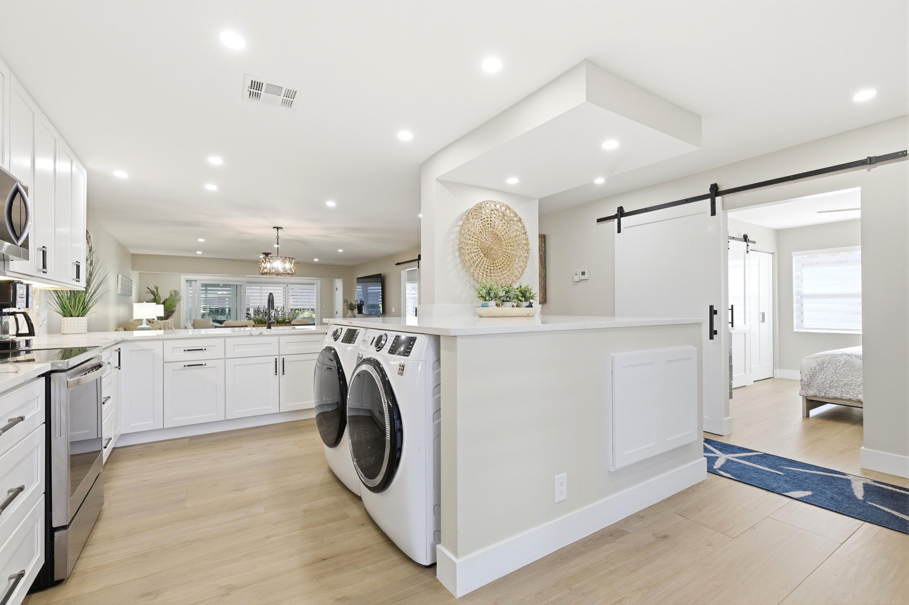 1415 Southwest 27th Avenue, Unit 104 Delray Beach, FL 33445 - Photo 4 of 43 a view of kitchen with washer and dryer