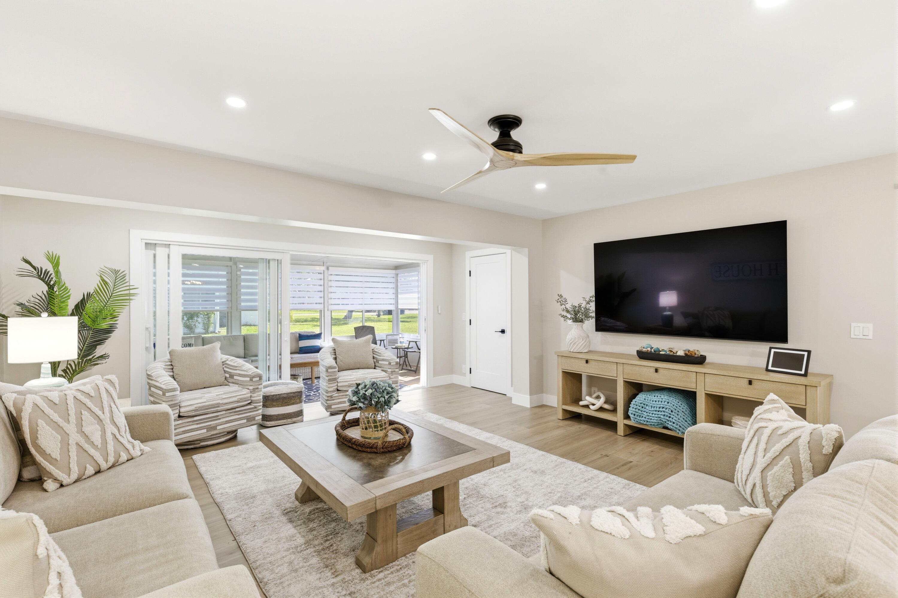 1415 Southwest 27th Avenue, Unit 104 Delray Beach, FL 33445 - Photo 10 of 43 a living room with furniture and a flat screen tv