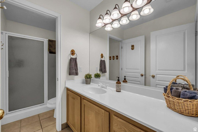 841 1010 S Street St. George, UT 84790 - Photo 26 of 33 Full bathroom featuring vanity, light tile patterned flooring, and a stall shower