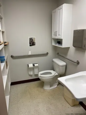 a white toilet sitting next to a bathroom sink