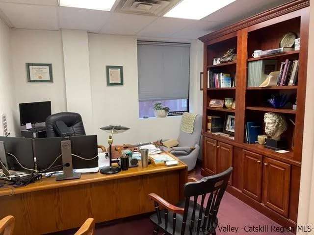 a room with a table chairs and a workspace