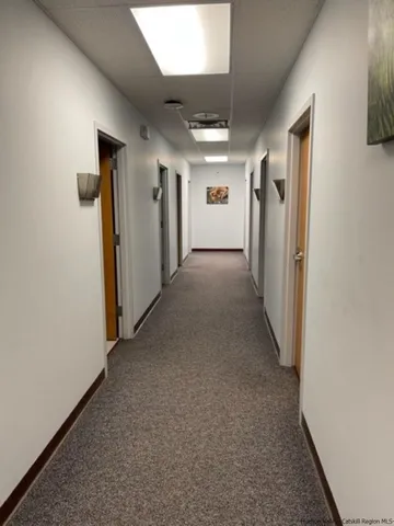 a view of a hallway with a refrigerator