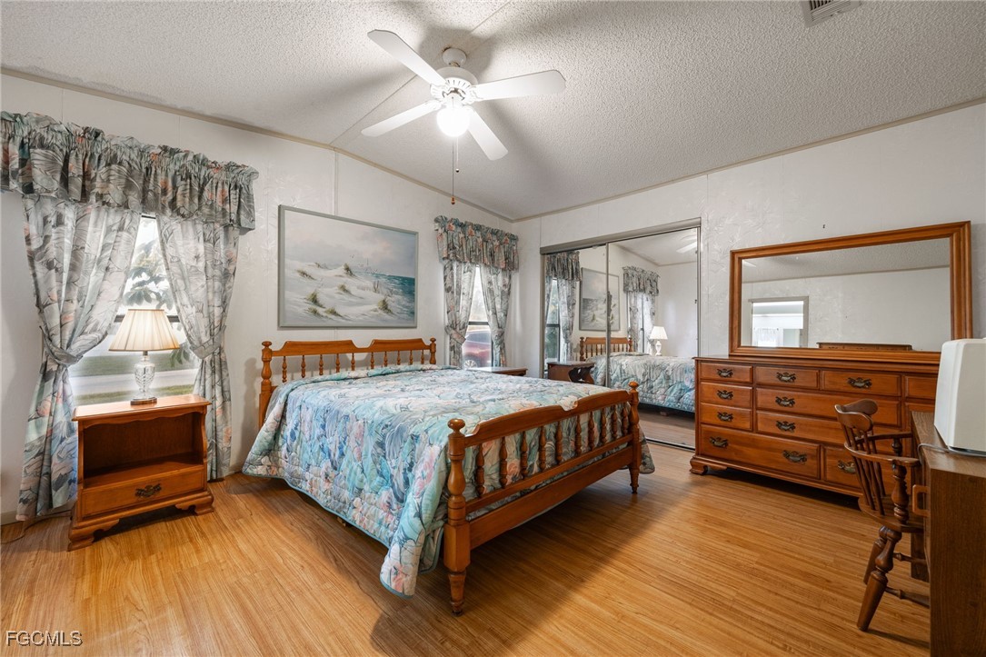 19658 Eagle Trace Court North Fort Myers, FL 33903 - Photo 18 of 40 a bedroom with a bed and a chandelier