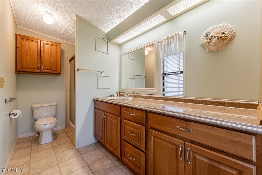 19658 Eagle Trace Court North Fort Myers, FL 33903 - Photo 19 of 40 a spacious bathroom with a granite countertop sink a toilet and a mirror