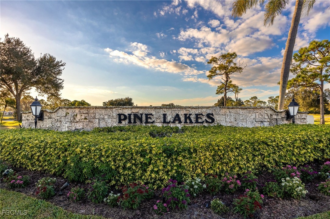 19658 Eagle Trace Court North Fort Myers, FL 33903 - Photo 27 of 40 a view of a green field with lots of flower plants and wooden fence
