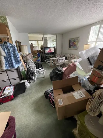a living room with furniture a window and a flat screen tv