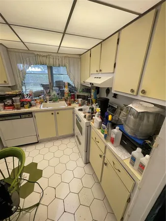a kitchen with a sink appliances and cabinets