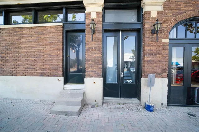 a view of a brick house with large windows
