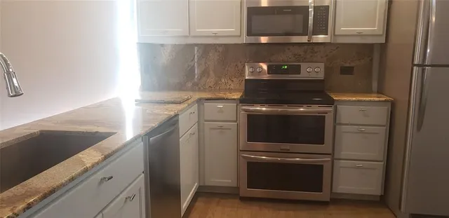 a kitchen with a stove and a microwave